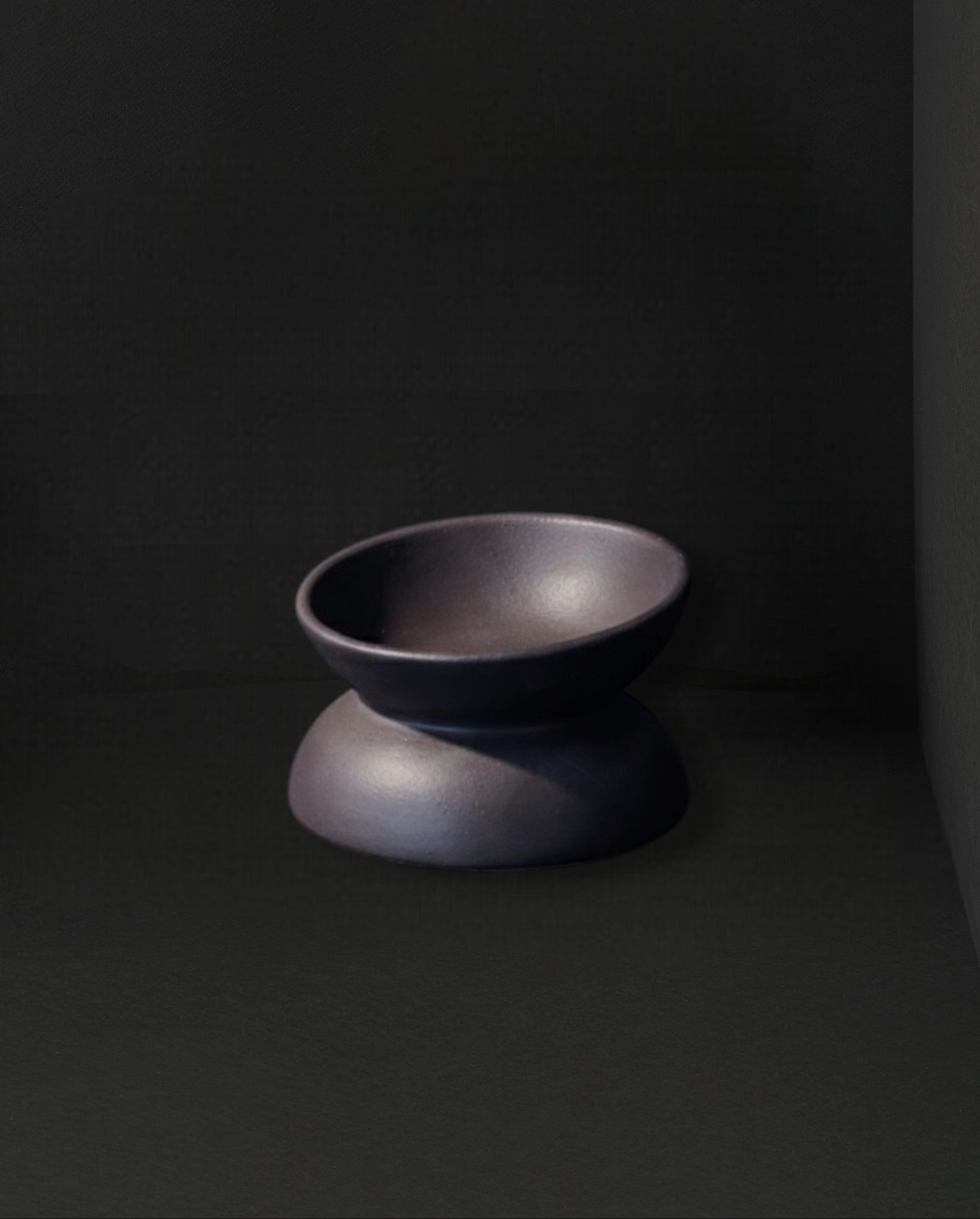 Dark gray ceramic bowl on a black background