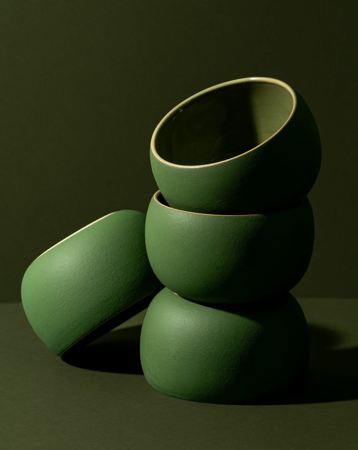 A stack of three white stoneware soup bowls of different sizes on a neutral background.