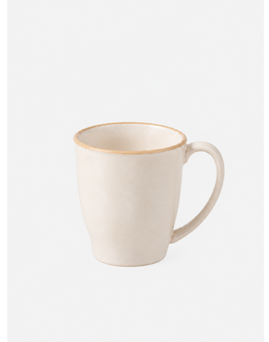 A ceramic coffee mug in a warm cream color with a thin gold rim, shown against a plain white background.